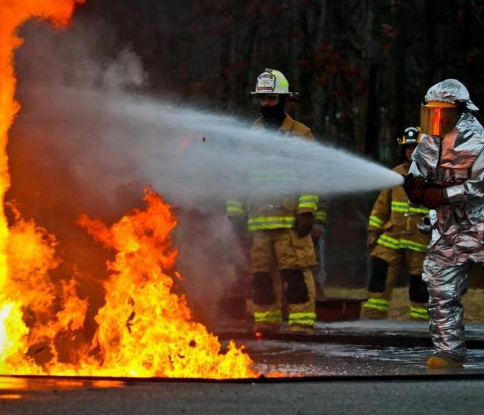 SERVPRO professionals combatting a fire. 