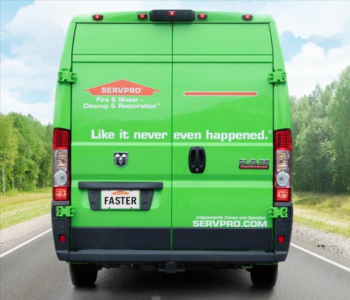 The double doors on the back of a SERVPRO marked van, sporting the logo, "Like it never even happened."